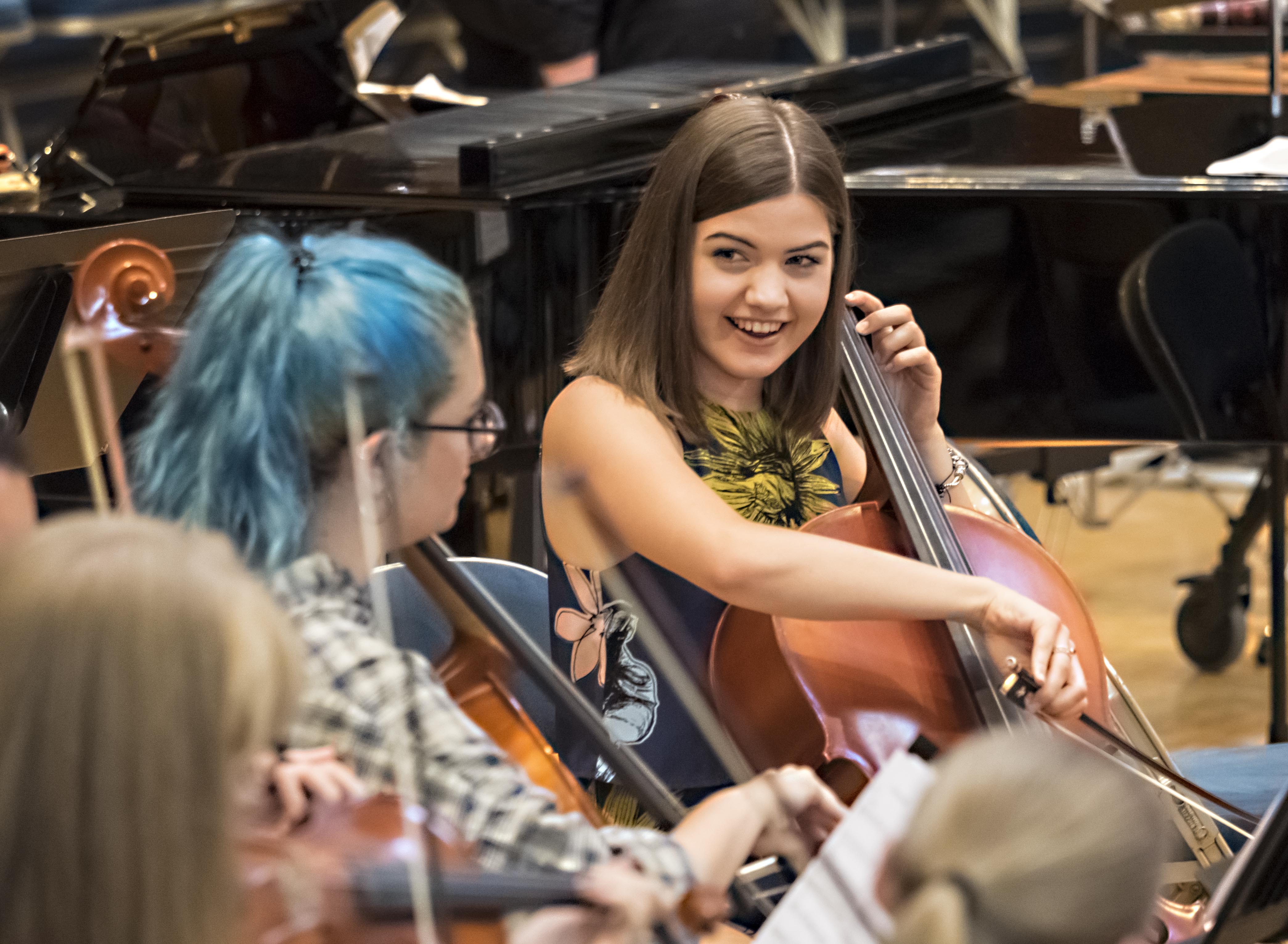Students playing the cello.