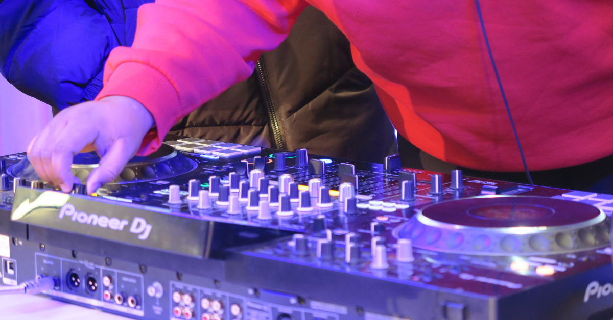 Hands playing with DJ decks.