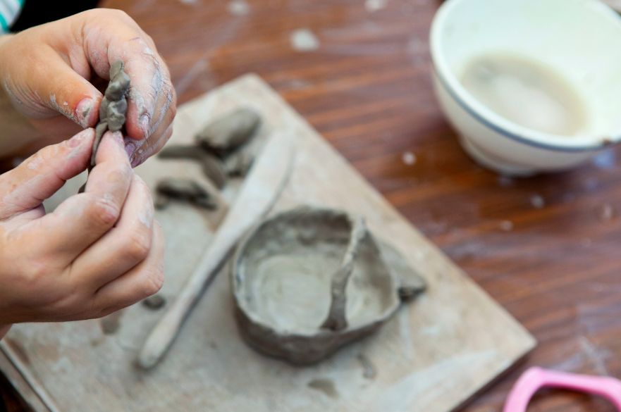A pair of hands moulding pottery.